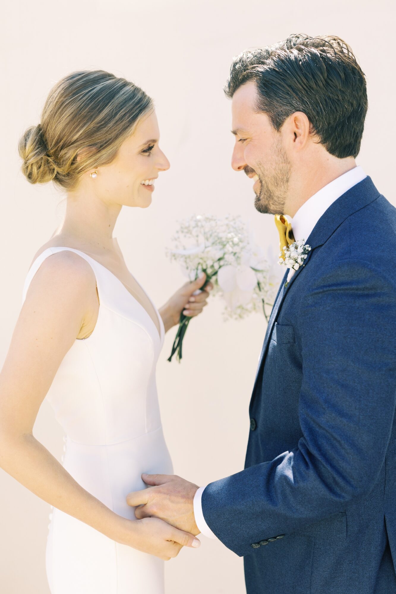 bride and groom holding hands